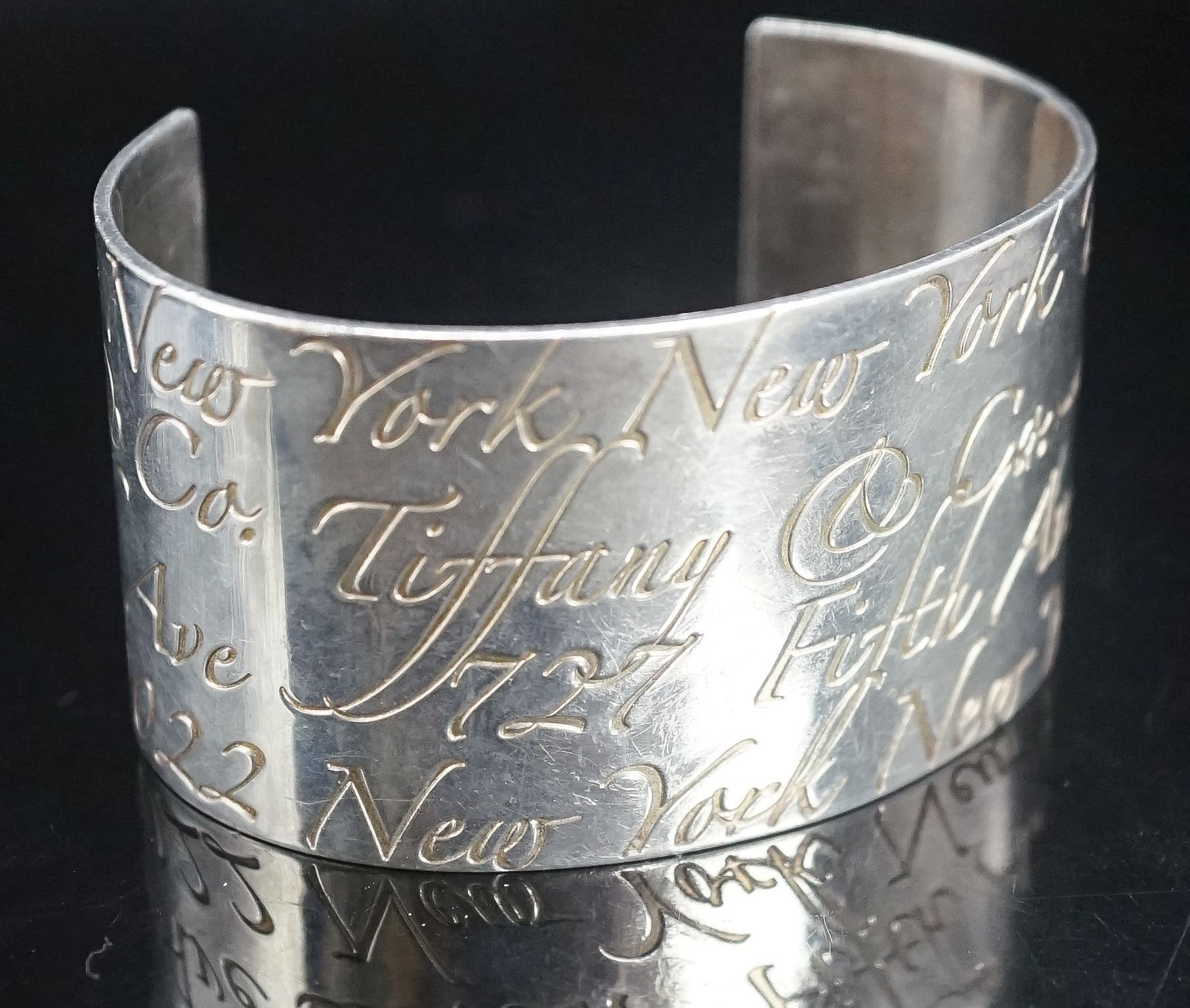 A Tiffany & Co 925 open bangle with engraved script, interior diameter approx. 69mm.